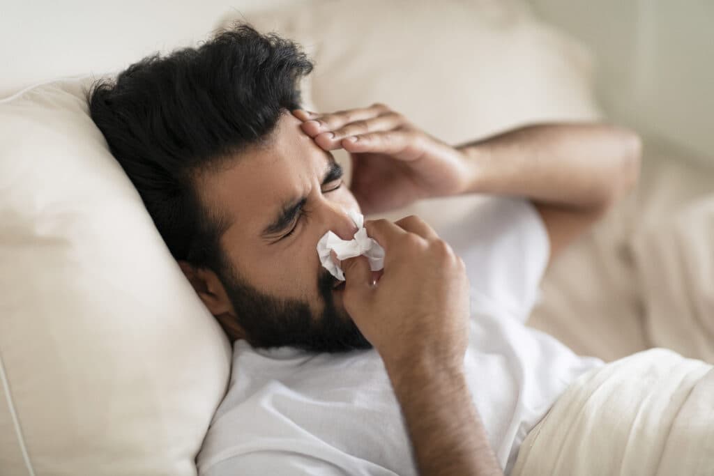 Person with nasal congestion and sinus pressure