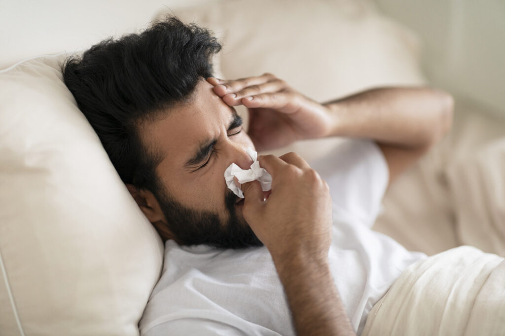 Person with nasal congestion and sinus pressure