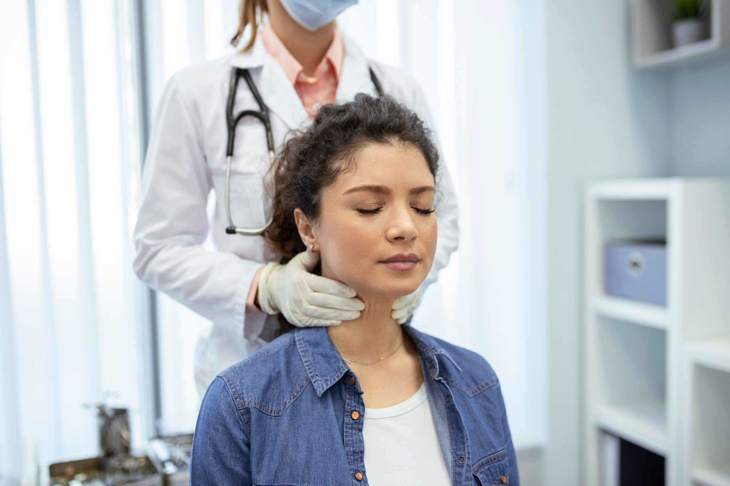 Woman examining hair for thyroid-related hair loss